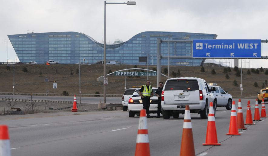 Denver Police Department officers block a ramp to the west side of the terminal at Denver International Airport after part of the facility was evacuated because of suspicious packages found in the terminal Tuesday, March 22, 2016, in Denver. The top two levels of the west side of the main terminal were evacuated before the bomb squad determined that the packages were not a threat. (AP Photo/David Zalubowski)