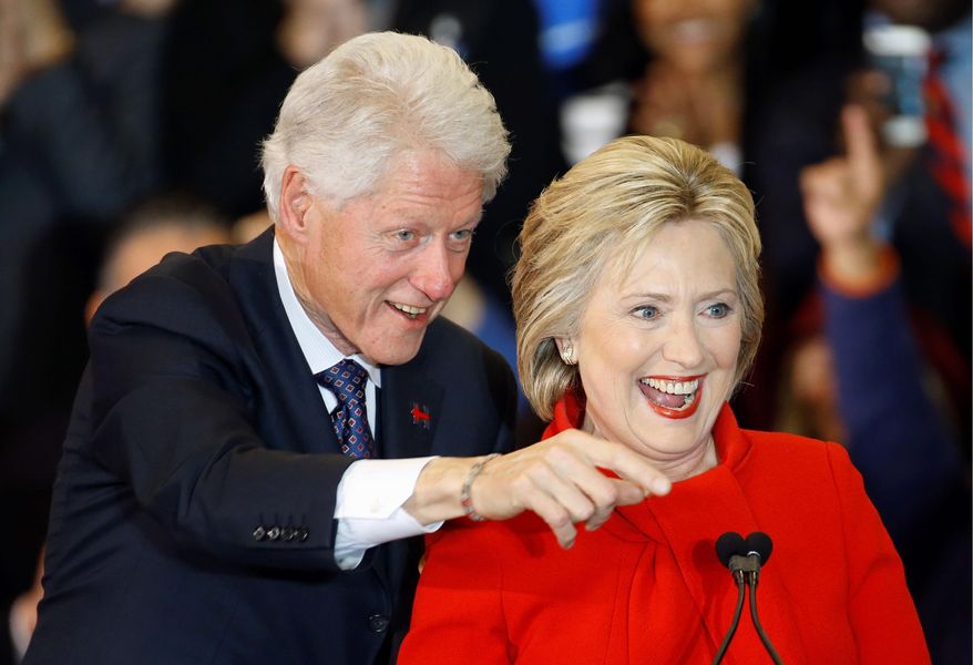 Former President Bill Clinton and Democratic presidential front-runner Hillary Clinton acknowledge supporters during a caucus night rally at Drake University in Des Moines, Iowa, on Feb. 1, 2016. (Associated Press) **FILE**