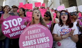 Planned Parenthood supporters rally for women&#39;s access to reproductive health care on &quot;National Pink Out Day&#39;&#39; at Los Angeles City Hall on Sept. 9, 2015. (Associated Press)