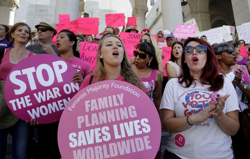 Planned Parenthood supporters rally for women&#39;s access to reproductive health care on &quot;National Pink Out Day&#39;&#39; at Los Angeles City Hall on Sept. 9, 2015. (Associated Press)