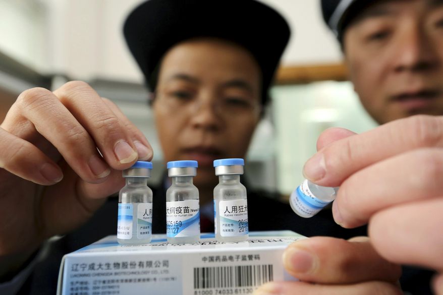 In this Monday, March 21, 2016 photo, officials from China's State Food and Drug Administration inspect vaccines stored at the local Center for Disease Control and Prevention office in Rong'an county in southwestern China's Guangxi Zhuang Autonomous Region. Police in eastern China have detained numbers of people implicated in a scandal involving the selling of poorly refrigerated and probably ineffective vaccines, state media reported Wednesday, March 23. (Chinatopix via AP) CHINA OUT