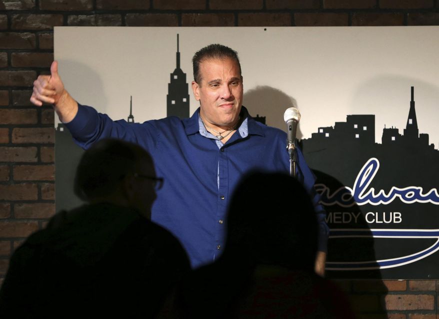 In this March 20, 2016 photo, actor-comedian Carlo Goias, of Toms River, N.J., gives a thumbs-up to an audience after a group comedians gave a benefit show for his legal defense at the Broadway Comedy Club in New York. Goias is facing 10 years in prison after he used a prop BB gun without a gun permit. He was charged under New Jersey's strict gun statute that requires permits for almost any fire arm, including the airsoft gun that Goias used while filming a car chase scene in an independent film. (AP Photo/Mel Evans)