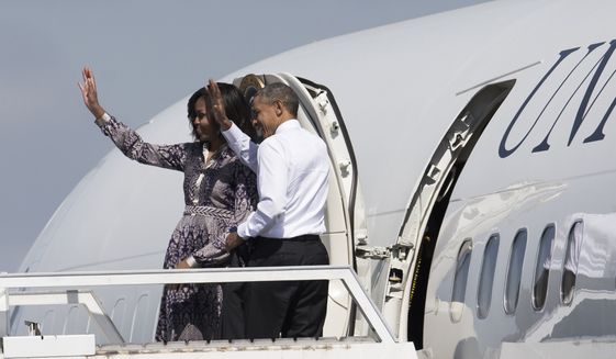 U.S. President Barack Obama and his wife, First Lady Michelle Obama, wave from the door of Air Force One, as they depart from the International Buenos Aires airport on their way to the resort town of Bariloche, Argentina, Thursday, March 24, 2016. (AP Photo/Ivan Fernandez) ** FILE **