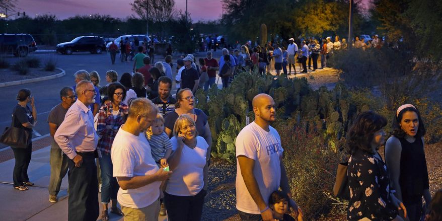 People wait in line to vote in the primary at the Environmental Education Center, Tuesday, March 22, 2016, in Chandler, Ariz. Residents in metro Phoenix have been bristling for years over a perception that state leaders want to make it harder for them to vote, and the mess at the polls Tuesday only heightened the frustration. (David Kadlubowski/The Arizona Republic via AP) MARICOPA COUNTY OUT; MAGS OUT; NO SALES; MANDATORY CREDIT