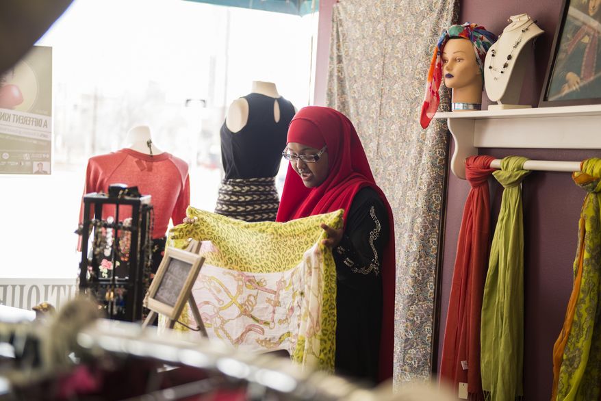 ADVANCE FOR USE MONDAY, MARCH 28, 2016, AND THEREAFTER- In this March 21, 2016, photo, Fatuma Mohammed speaks to a customer at Sisterhood Boutique in Minneapolis. Sisterhood Boutique, which celebrated its second anniversary last month, allows women ages 16-21 to take part in a four-month internship to help build and develop their business skills, The Minnesota Daily reported. (Maddy Fox/The Minnesota Daily via AP) MANDATORY CREDIT