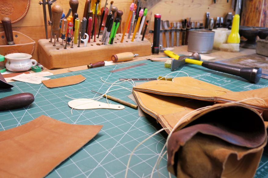 ADVANCE FOR SATURDAY MARCH 26 AND THEREAFTER - In a Feb. 25, 2016 photo, pieces of cowhide that will one day support the feet of a working cowboy rest on a bench at Buster's Boot Company shop near Akeley, Minn. The uppers are done, waiting for Craig Bartels to finish the rest of the boot. Bartels owns and runs Buster's Boot Company, one of the last custom bootmakers in the Midwest. (John Enger/Minnesota Public Radio via AP) MANDATORY CREDIT
