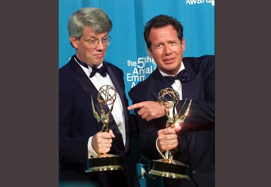 FILE - In this Sept. 13, 1998 file photo, Peter Tolan, left, and Garry Shandling pose with their Emmy awards for outstanding writing for a comedy series award for "The Larry Sanders Show," at the 50th Annual Primetime Emmy Awards in Los Angeles. Shandling, who as an actor and comedian pioneered a pretend brand of self-focused docudrama with "The Larry Sanders Show," died, Thursday, March 24, 2016 of an undisclosed cause in Los Angeles. He was 66. (AP Photo/Victoria Arocho, File)