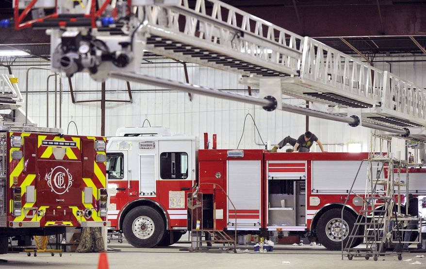 ADVANCE FOR THE WEEKEND OF MARCH 26-27 AND THEREAFTER - In a Feb. 23, 2016 photo, Nick Harding works atop a 105-foot ladder truck destined for Omaha at the Smeal Fire Apparatus company in Snyder, Neb. The Smeal Fire Apparatus Co. plant sits on the western edge of Snyder, a town of of 298, not far from Fremont, and it employs more people than that in jobs ranging from the front offices to the production lines working on 45 to 60 firetrucks at a time. (Eric Gregory/The Journal-Star via AP) LOCAL TELEVISION OUT; KOLN-TV OUT; KGIN-TV OUT; KLKN-TV OUT; MANDATORY CREDIT