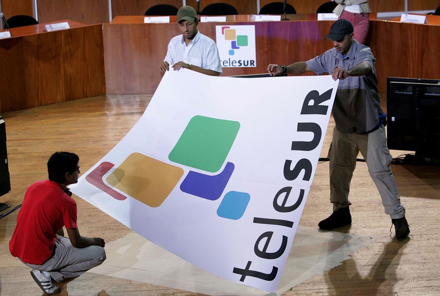 FILE - In this July 24, 2005, file photo, workers set up for the inauguration of Telesur in Caracas, Venezuela. Argentine Minister of Communication Hermann Lombardi announced Monday, March 28, 2016, that the country is pulling out of the Spanish-language television network started by the late Venezuelan President Hugo Chavez as a vehicle for promoting leftist politics in Latin America. (AP Photo/Leslie Mazoch,File)