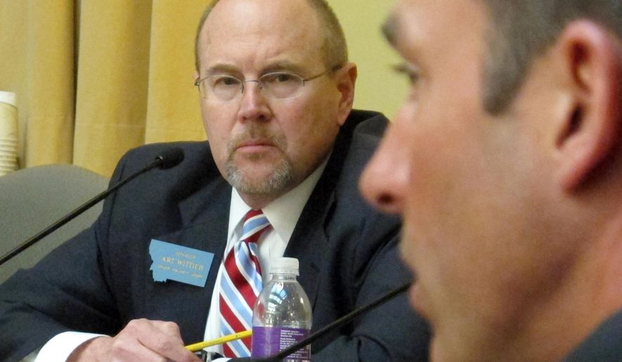 FILE - This April 2, 2013 file photo shows Montana Senate Majority Leader Art Wittich, left, during a caucus meeting in Helena, Mont. The trial of the Montana legislator accused of taking dark money during his 2010 re-election campaign is set to get underway Monday, March 28, 2016. (AP Photo/Matt Gouras, file)