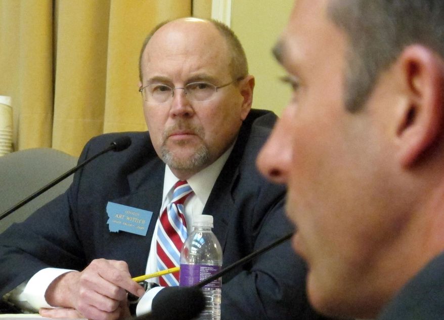 FILE - This April 2, 2013 file photo shows Montana Senate Majority Leader Art Wittich, left, during a caucus meeting in Helena, Mont. The trial of the Montana legislator accused of taking dark money during his 2010 re-election campaign is set to get underway Monday, March 28, 2016. (AP Photo/Matt Gouras, file)