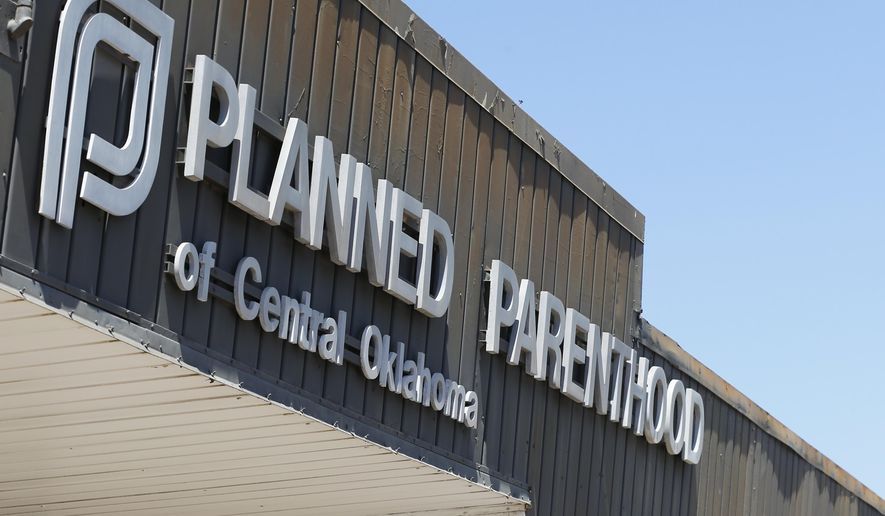 This July 24, 2015, file photo shows a sign at a Planned Parenthood Clinic in Oklahoma City. (AP Photo/Sue Ogrocki, File)