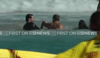 Australian actor Hugh Jackman sprang into action Saturday when several swimmers got caught in a riptide at Sydney&#39;s Bondi Beach. (Nine News screengrab)