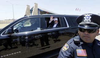 In this July 23, 2015, file photo, Republican presidential candidate Donald Trump waves from his vehicle during a tour of the the World Trade International Bridge along the U.S.-Mexico border in Laredo, Texas. (AP Photo/LM Otero, File)