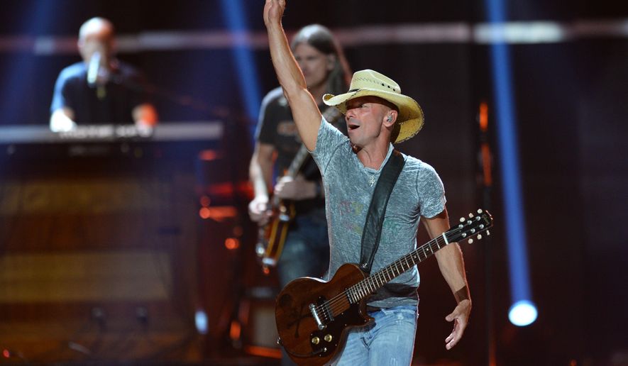 FILE - In this Sept. 18, 2015 file photo, Kenny Chesney performs at Day 1 of the 2015 iHeartRadio Music Festival at the MGM Grand Garden Arena in Las Vegas. Chesney is getting his own "No Shoes Radio" channel on satellite radio's SiriusXM, seeking more exposure for an online venture he started in 2008 to share music with fans. SiriusXM said Tuesday, March 29, 2016, that the service will launch on April 12. (Photo by Al Powers/Powers Imagery/Invision/AP)