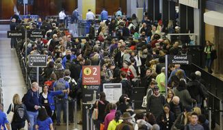 In this March 17, 2016, photo, travelers wait in line for security screening at Seattle-Tacoma International Airport in Seattle. Fliers will likely face massive security lines at airports across the country this summer, with airlines already warning passengers to arrive at least two hours early or risk missing their flight. (AP Photo/Ted S. Warren)