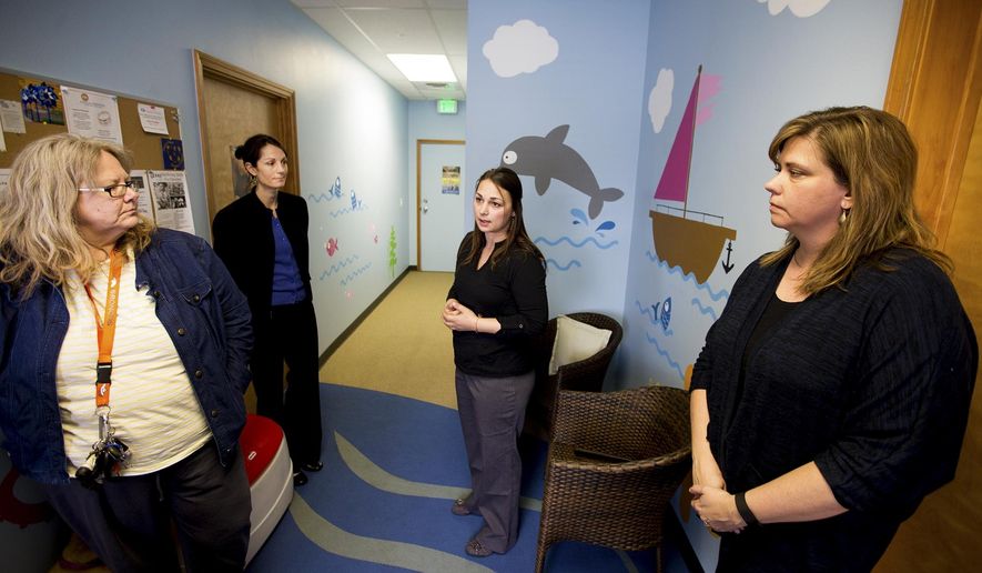 ADVANCE FOR THE WEEKEND OF APRIL 2-3 AND THEREAFTER - In a In a Tuesday, March 22, 2016 photo, From left to right, mental health clinician Sheri Weistaner, Executive Director of Safe Passage Katie Coker, Children's Advocacy Center Director Tamarah Cardwell and forensic investigator Janet Pace stand in the waiting room of the Children's Advocacy Center in Coeur d'Alene, Idaho. (Jake Parrish/Coeur d'Alene Press via AP) MANDATORY CREDIT