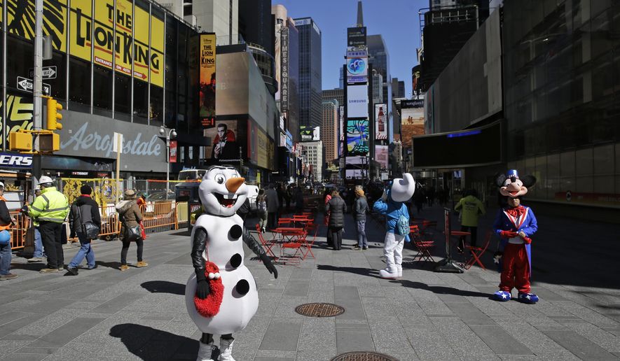 Costumed characters work for tips in Times Square in New York, Tuesday, March 29, 2016. The costumed characters, naked painted ladies and bus tour ticket sellers who have made all of Times Square their stomping grounds could be restricted to specific zones under legislation being considered by the City Council. The council’s committee on transportation is holding a hearing Wednesday morning on legislation that would allow the city’s Department of Transportation to create rules and regulations for pedestrian plazas like the ones in Times Square. (AP Photo/Seth Wenig)