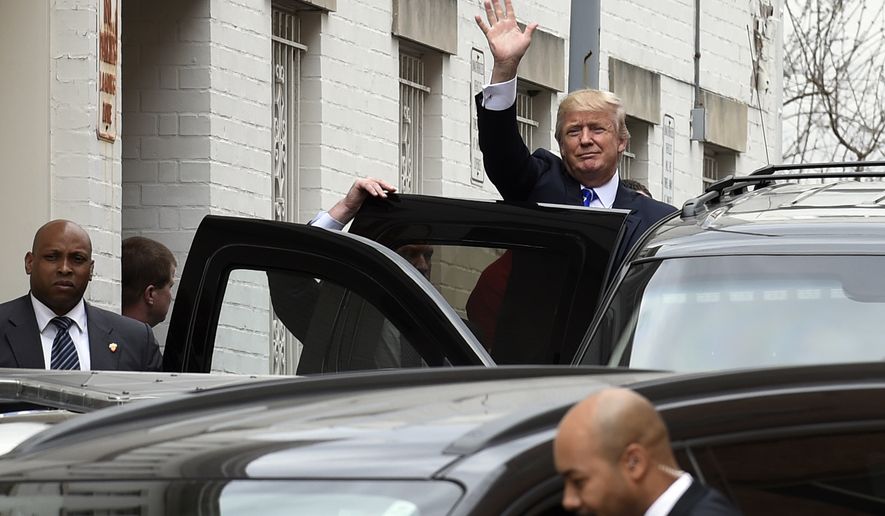 Republican presidential candidate Donald Trump waves as he gets into his vehicle in Washington, Thursday, March 31, 2016, following a meeting at the Republican National Committee. (AP Photo/Susan Walsh)