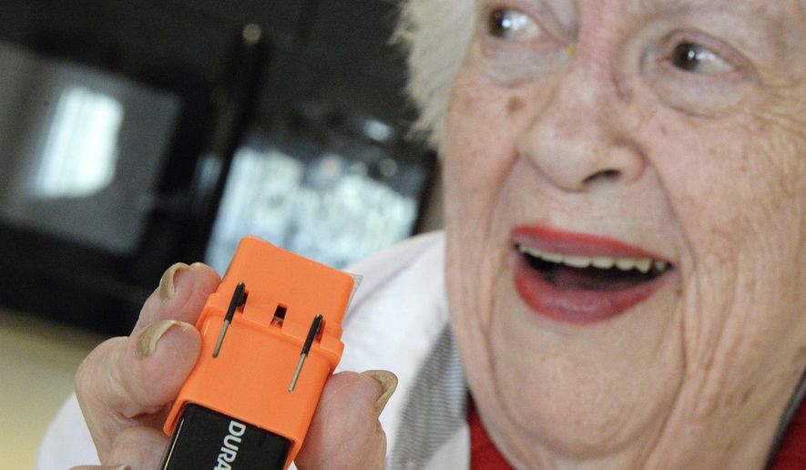 ADVANCE FOR USE SUNDAY, APRIL 3 AND THEREAFTER - In this March 8, 2016 photo, Delores Hirst, 85, of Normal, Ill., who is legally blind, holds a liquid level identifier which gives an audible signal to the user to reduce spills. The device was provided by LIFE Center for Independent Living to help people with low vision remain as independent as possible. (Steve Smedley/The Pantagraph via AP) MANDATORY CREDIT