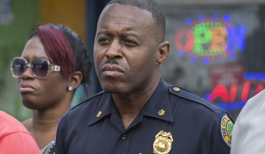 In this Jan. 2, 2016, photo, Miami Police Maj. Delrish Moss stands among the Miami-Dade officials who announced the arrest of Willie "Pee Wee" Wilcher in Liberty City, Fla. Moss was announced as police chief in Ferguson, Mo., Thursday, March 31, 2016, putting a black man in charge of a mostly white department that serves a town where African-Americans make up two-thirds of the residents. (Matias J. Ocner/The Miami Herald via AP) MAGS OUT; MANDATORY CREDIT