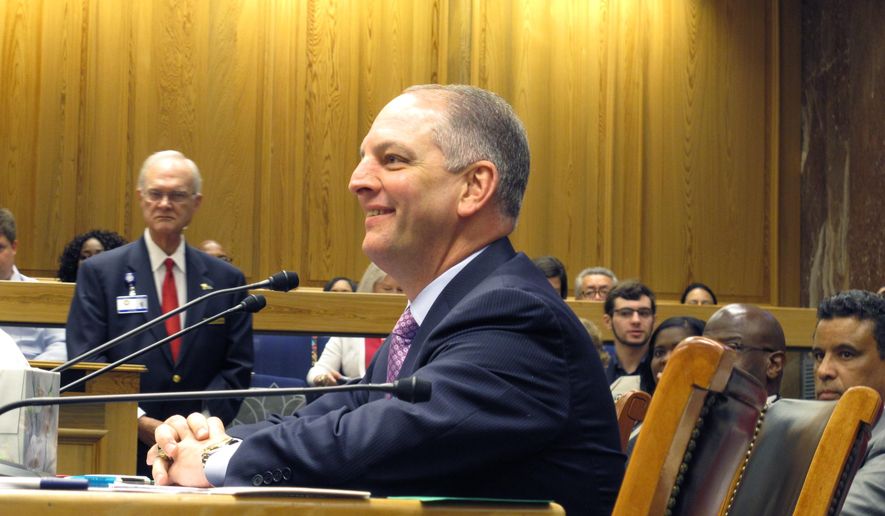Gov. John Bel Edwards smiles as he readies to testify in the Senate Labor Committee in support of his minimum wage increase and equal pay bills, on Thursday, March 31, 2016, in Baton Rouge, La. (AP Photo/Melinda Deslatte)