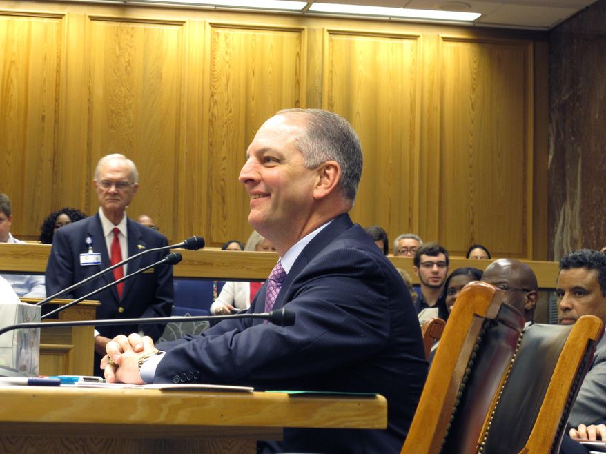 Gov. John Bel Edwards smiles as he readies to testify in the Senate Labor Committee in support of his minimum wage increase and equal pay bills, on Thursday, March 31, 2016, in Baton Rouge, La. (AP Photo/Melinda Deslatte)
