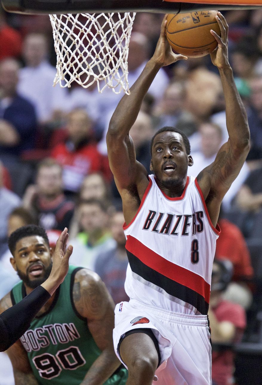 Portland Trail Blazers forward Al-Farouq Aminu, right, dunks in front of Boston Celtics forward Amir Johnson during the second half of an NBA basketball game in Portland, Ore., Thursday, March 31, 2016. (AP Photo/Craig Mitchelldyer)