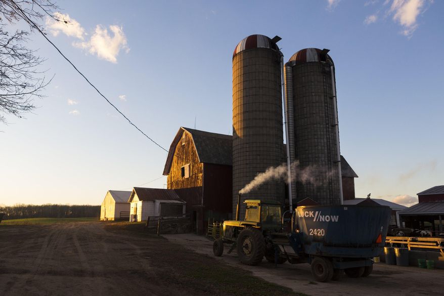 ADVANCE FOR SUNDAY APRIL 3 AND THEREAFTER - In a Thursday, Nov. 19, 2015 photo, Justin Parks, 26, moves his tractor in the late afternoon sun on his farm in Jackson, Mich. Parks inherited the farm from his father, who passed away from bile duct cancer in December 2013. Parks is an increasingly rare type of farmer because he is young - 26 - and his mostly one-man operation is small. (Nick Gonzales/Jackson Citizen Patriot via AP) LOCAL STATIONS OUT; LOCAL INTERNET OUT; MANDATORY CREDIT (Nick Gonzales | Mlive.com)