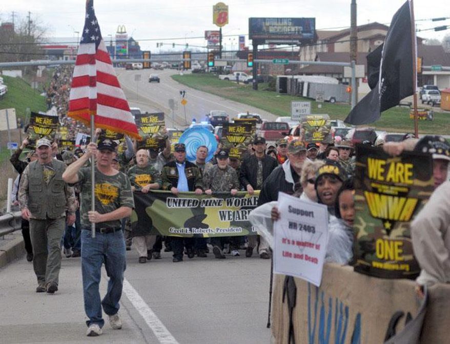 Thousands of members with the United Mine Workers of America march down Route 21 to the Greene County Fairgrounds near Waynesburg, Pa., for a solidarity rally Friday, April 1, 2016. (Celeste Van Kirk/Observer-Reporter via AP)
