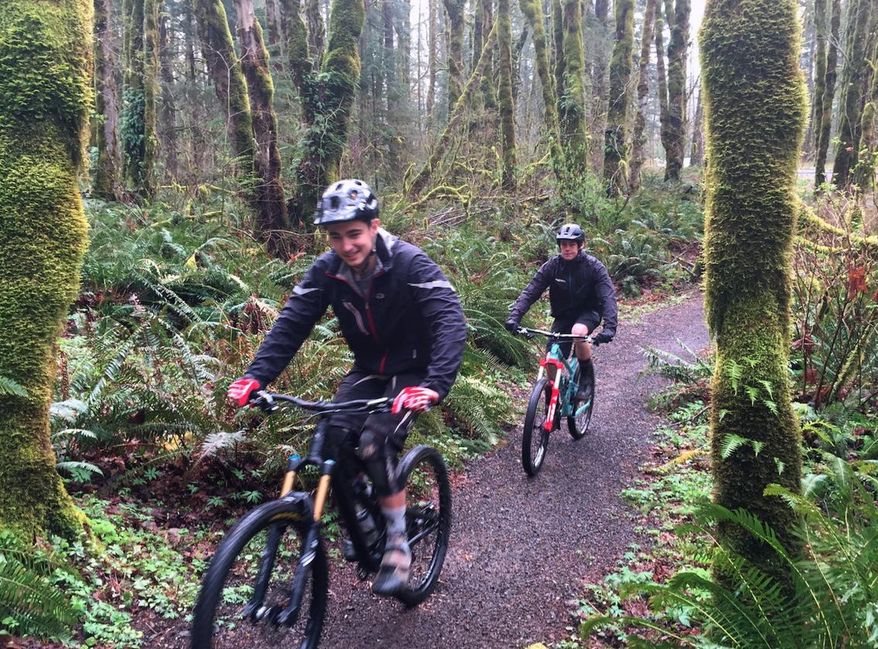In this March 22, 2016 photo, Henry Fitzgerald, left, and Daniel Shaw ride the Sandy Ridge Trail System east of Sandy, Ore. The county is in final negotiations to sell the land to the U.S. Bureau of Land Management. Profits from the sale will be used to buy timberlands elsewhere. In addition to adding up to two miles of new trails to the system, the sale will allow BLM to roughly double the current parking at the trailhead. (Dana Tims/The Oregonian via AP) MAGS OUT; TV OUT; NO LOCAL INTERNET; THE MERCURY OUT; WILLAMETTE WEEK OUT; PAMPLIN MEDIA GROUP OUT; MANDATORY CREDIT
