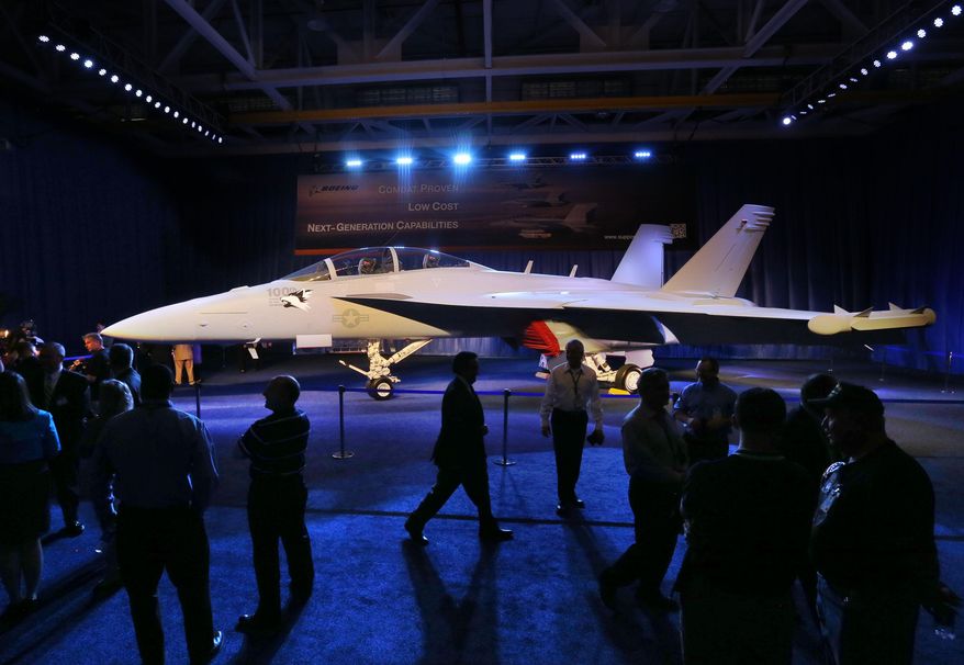 FOR RELEASE FRIDAY, APRIL 1, 2016, AT 12:01 A.M. CDT.- This photo taken May 5, 2014, shows workers walking around an EA-18G Growler produced at the Boeing plant in St. Louis after a rally celebrating delivery of the 100th Growler to the Navy. Federal spending in Missouri in 2014 was the equivalent of 22.8 percent of the state's economy, tying it with Rhode Island for 18th nationally among the states. (David Carson/St. Louis Post-Dispatch via AP)