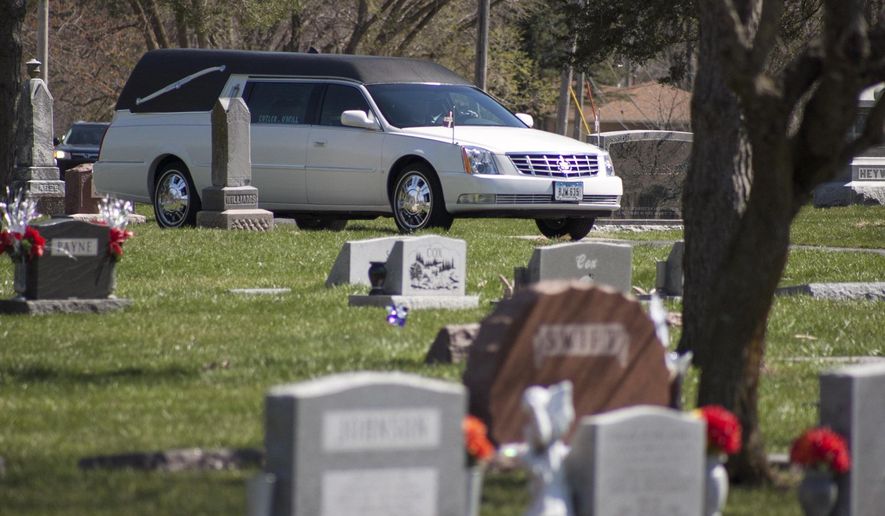The funeral procession for Tosha Nicole Hyatt arrives at Garner Township Cemetery, Saturday, April 2, 2016 in Council Bluffs, Iowa. Hyatt was in a police SUV, being transported from Council Bluffs to Des Moines on an arrest warrant, when the crash occurred March 26. Des Moines police officers Susan Farrell and Carlos Puente-Morales, and Benjamin Beary of Knoxville, the driver of the other vehicle involved, were also killed. (Joe Shearer/The Daily Nonpareil via AP) MANDATORY CREDIT