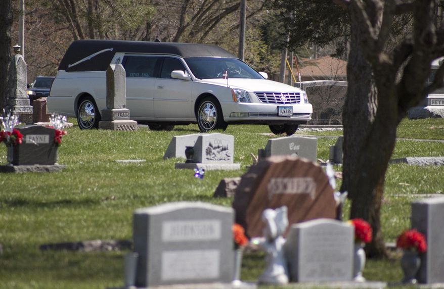 The funeral procession for Tosha Nicole Hyatt arrives at Garner Township Cemetery, Saturday, April 2, 2016 in Council Bluffs, Iowa. Hyatt was in a police SUV, being transported from Council Bluffs to Des Moines on an arrest warrant, when the crash occurred March 26. Des Moines police officers Susan Farrell and Carlos Puente-Morales, and Benjamin Beary of Knoxville, the driver of the other vehicle involved, were also killed. (Joe Shearer/The Daily Nonpareil via AP) MANDATORY CREDIT