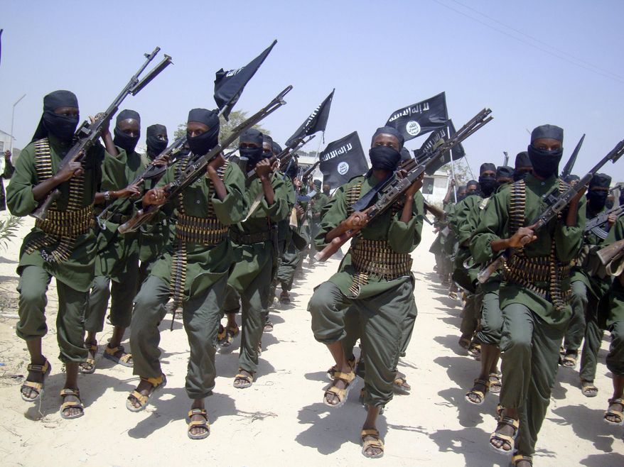 FILE - In this Thursday, Feb. 17, 2011 file photo, al-Shabab fighters march with their weapons during military exercises on the outskirts of Mogadishu, Somalia. A U.S. drone strike in Somalia has targeted a key leader of the al-Shabab militant group who was involved in two attacks in Mogadishu more than a year ago that killed more than 30 people, at least three Americans among them, the Pentagon said Friday, April 1, 2016. Several U.S. officials said he and two others were killed. Hassan Ali Dhoore was targeted in the airstrike Thursday, but the U.S. military was still assessing the results, Pentagon spokesman Peter Cook said in a statement. (AP Photo/Mohamed Sheikh Nor, File)