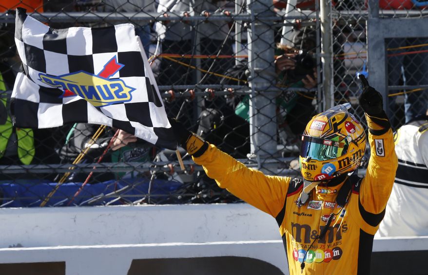 Kyle Busch celebrates winning the Sprint Cup auto race at Martinsville Speedway on Sunday, April 3, 2016, in Martinsville, Va. (AP Photo/Steve Helber)