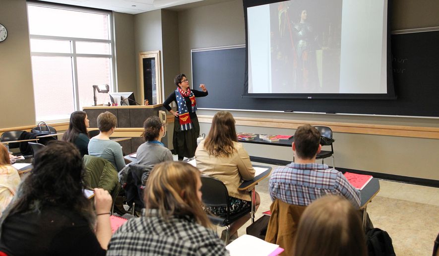 ADVANCE FOR WEEKEND EDITIONS - In this Thursday, March 3, 2016 photo, Anna Barker leads discussion in her course, "Wonder Woman Unleashed: A Hero for Our Times," at the Adler Journalism Building in Iowa City, Iowa. (David Scrivner/Iowa City Press-Citizen via AP) MANDATORY CREDIT