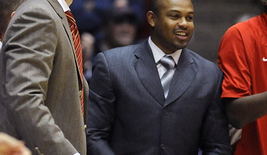 FILE - In this Nov. 17, 2013, file photo, Illinois State associate head basketball coach Torrey Ward, right, and head coach Dan Muller smile after a college basketball game in Evanston, Ill. Ward was one of seven people killed in a small plane crash near Bloomington, Ill., one year ago on April 7, 2015, as the plane was returning from the NCAA Final Four tournament. Members of the Illinois State University community continue to grapple with last April&#39;s tragedy. (AP Photo/Matt Marton, File)