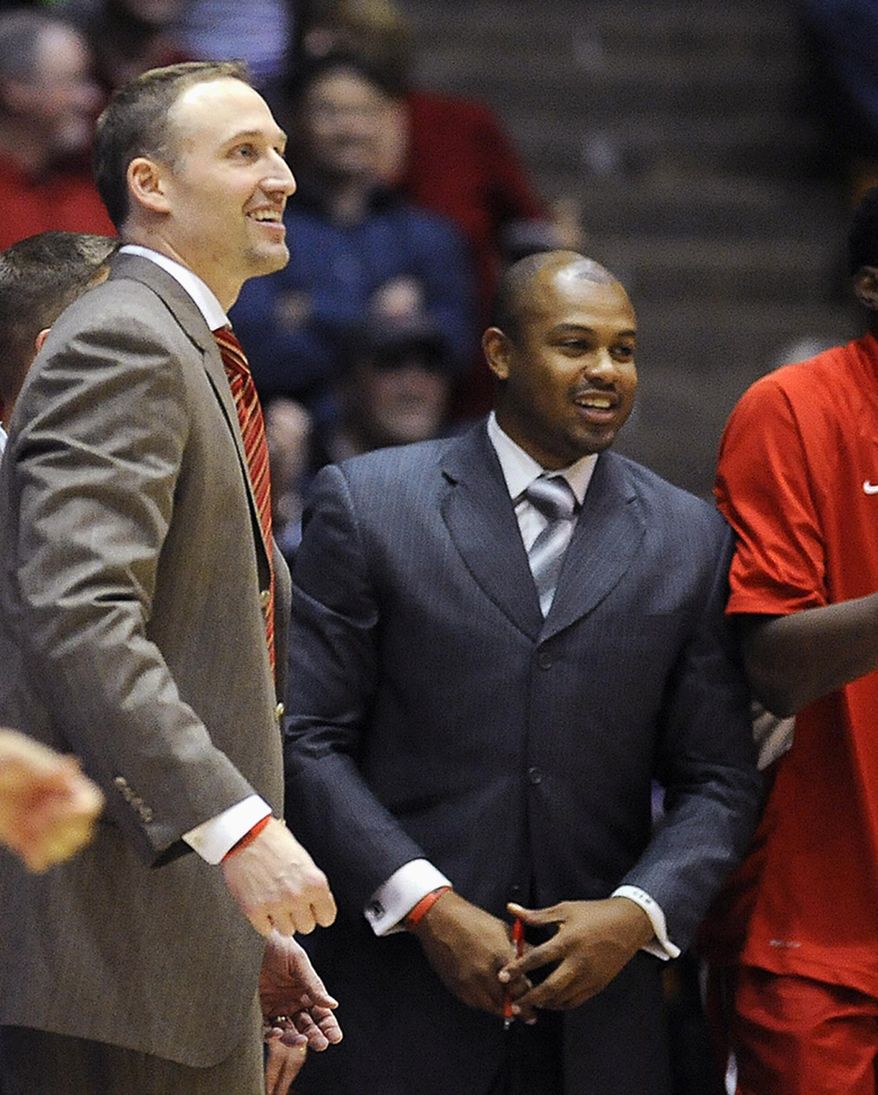 FILE - In this Nov. 17, 2013, file photo, Illinois State associate head basketball coach Torrey Ward, right, and head coach Dan Muller smile after a college basketball game in Evanston, Ill. Ward was one of seven people killed in a small plane crash near Bloomington, Ill., one year ago on April 7, 2015, as the plane was returning from the NCAA Final Four tournament. Members of the Illinois State University community continue to grapple with last April's tragedy. (AP Photo/Matt Marton, File)