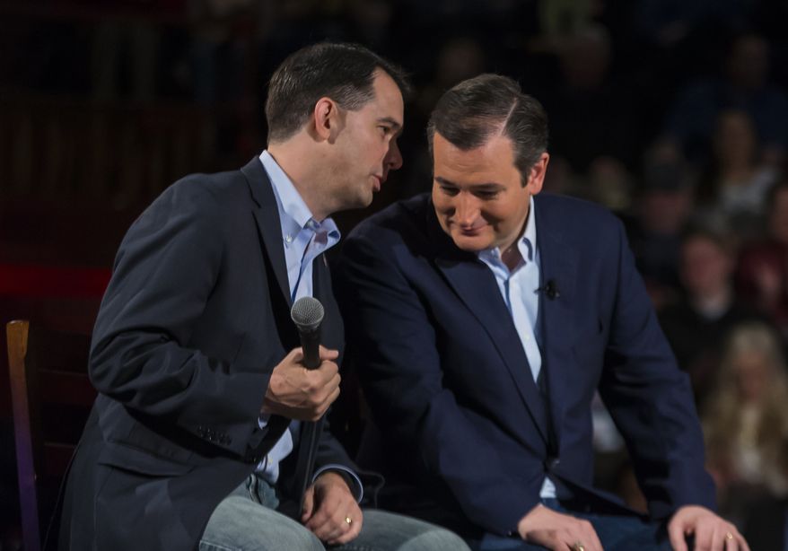 Republican presidential candidate, Sen. Ted Cruz, right, R-Texas, shares a moment with Wisconsin Gov. Scott Walker at a campaign stop, Monday, April 4, 2016, in Madison, Wis. (AP Photo/Andy Manis)