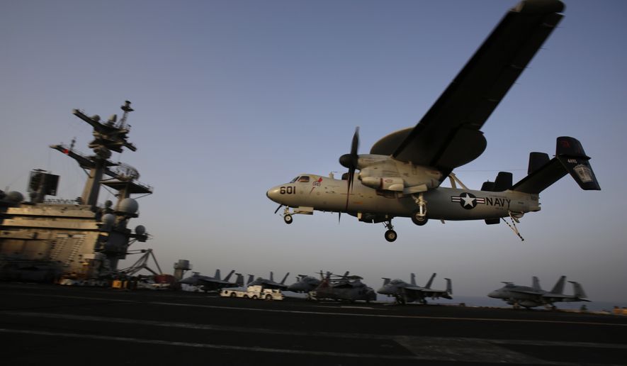 In this Aug. 10, 2014, file photo, an aircraft lands after missions targeting the Islamic State group in Iraq from the deck of the U.S. Navy aircraft carrier USS George H.W. Bush in the Persian Gulf. (AP Photo/Hasan Jamali, File)