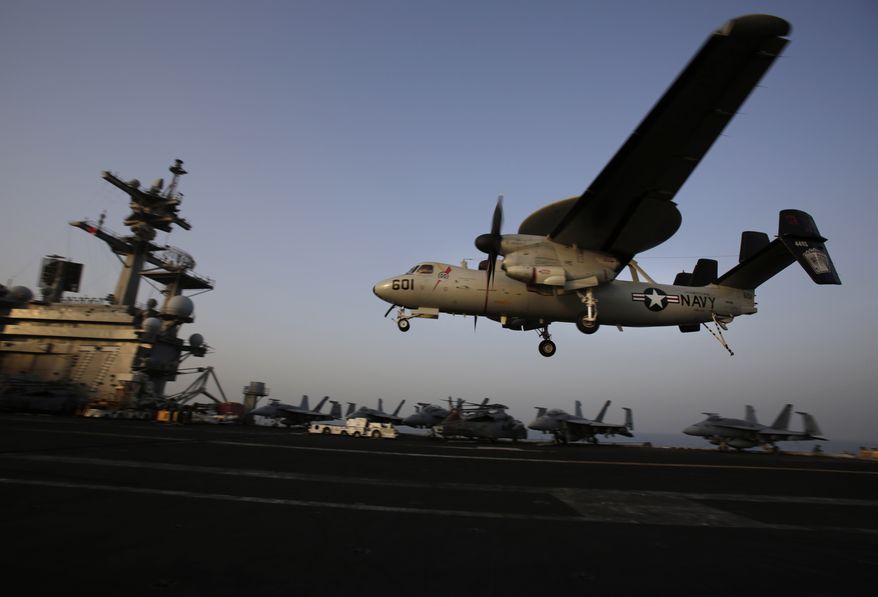 In this Aug. 10, 2014, file photo, an aircraft lands after missions targeting the Islamic State group in Iraq from the deck of the U.S. Navy aircraft carrier USS George H.W. Bush in the Persian Gulf. (AP Photo/Hasan Jamali, File)