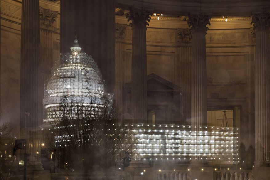FILE - In this Feb. 24, 2016, file photo, the Capitol in Washington is illuminated during a thunderstorm with the rotunda of the Russell Senate Office Building reflected on the rain-covered windows. Congress increasingly is defined by what it's not doing this election year. The Senate returns this week with a strong majority of Republicans saying no to confirmation hearings and a vote on President Barack Obama's Supreme Court nominee. (AP Photo/J. Scott Applewhite, File)