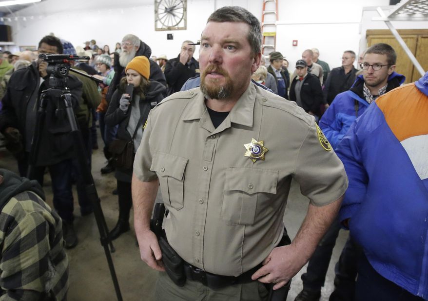 FILE - In this Jan. 6, 2016 file photo, Harney County Sheriff David Ward arrives at a community meeting at the Harney County fairgrounds in Burns, Ore. The contrasting actions of two rural Oregon sheriffs during the recent armed standoff at a national wildlife refuge were striking: one worked with federal officials to end the siege while another questioned the FBI’s authority and offered words of support for the ragtag group that seized property in the state’s high desert country. Ward, whose jurisdiction includes the Malheur National Wildlife Refuge, cooperated with federal and state police and became one of the public faces of the standoff. He urged standoff leader Ammon Bundy and his followers to stand down and respect the law. (AP Photo/Rick Bowmer, File)