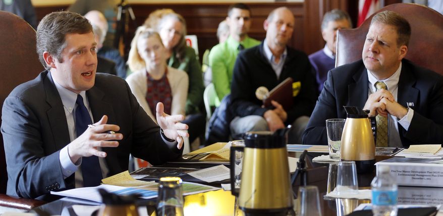 In this March 30, 2016 photo, gubernatorial hopefuls Colin Van Ostern, left, a Democrat and Chris Sununu a Republican, talk at the Governor and Council information hearing about the Mount Sunapee expansion plan in Concord, N.H. A yearslong effort to expand a ski mountain will finally get an up-or-down vote and, with it, force two gubernatorial candidates to pick sides in an emotional and unique New Hampshire issue. The Executive Council is set to vote Wednesday, April 6, 2016, on whether to approve the expansion, which includes more lifts and trails, at Mount Sunapee Resort. (AP Photo/Jim Cole)