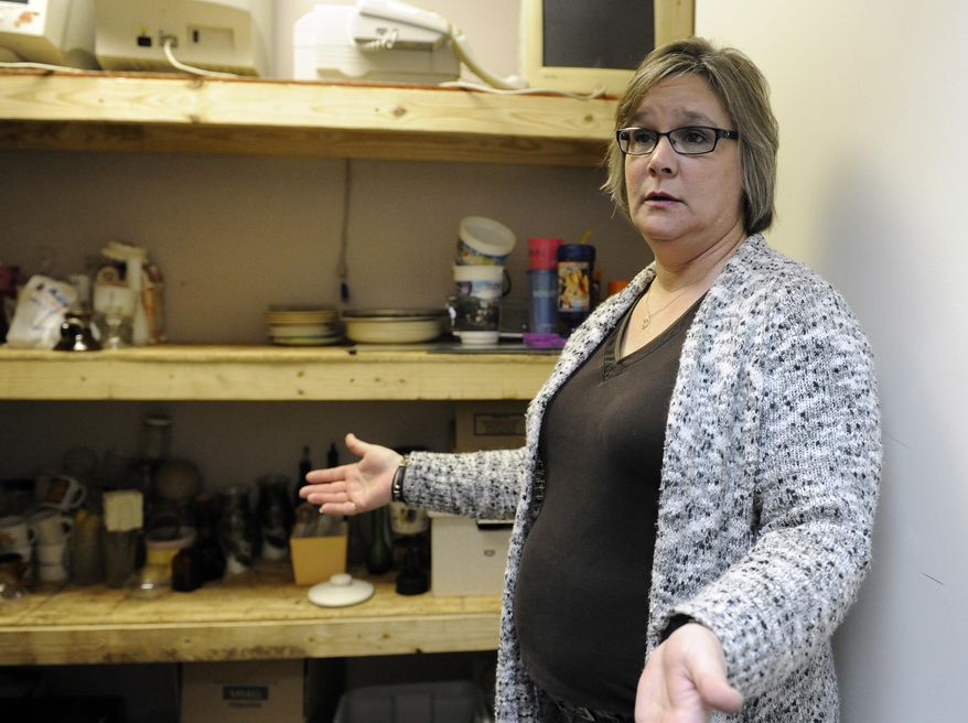 Standing in a supply closet, Shawn Baker talks about her new career Feb. 26, 2016, in Houston. After Baker, 45, was laid off from a job building power units for offshore oil rigs she went into business for herself with an offbeat idea called Tantrums, a paid service that lets customers take out their frustrations by smashing plates, televisions and other objects in various rooms with sledgehammers, bats and pipes. (AP Photo/Pat Sullivan)