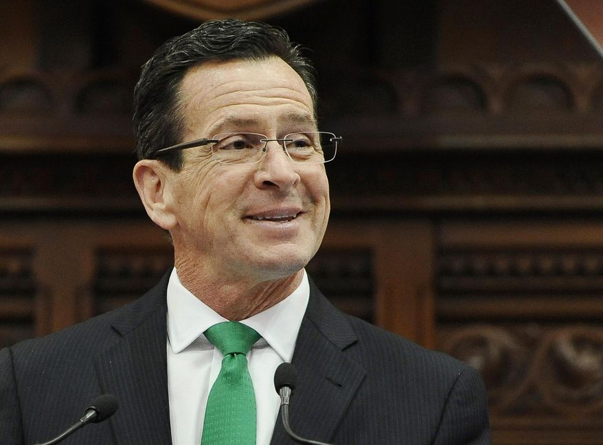 FILE - In this Jan. 7, 2015, file photo, Connecticut Gov. Dannel P. Malloy smiles during the State of the State address to a joint session of the legislature in the House Chambers at the Capitol in Hartford, Conn. Malloy was named Monday, April 4, 2016, as recipient of the annual John F. Kennedy Profile in Courage Award for supporting the resettlement of Syrian refugees in the U.S. following the November 2015 Paris terrorist attacks. Malloy personally welcomed a Syrian family to Connecticut after Indiana officials objected to their resettlement there. He is scheduled to receive the award in Boston on May 1. (AP Photo/Jessica Hill, File)
