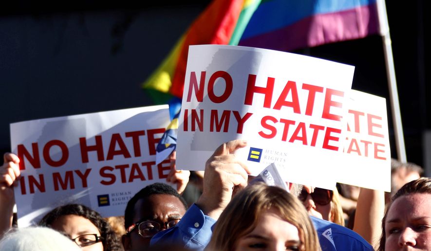 Protesters call for Mississippi Gov. Phil Bryant to veto House Bill 1523, which they say allows discrimination against LGBT people, during a rally on Monday. (Associated press)