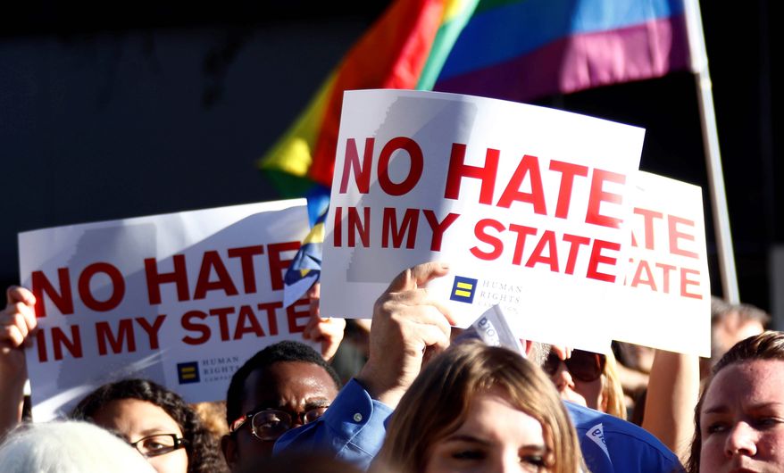 Protesters call for Mississippi Gov. Phil Bryant to veto House Bill 1523, which they say allows discrimination against LGBT people, during a rally on Monday. (Associated press)