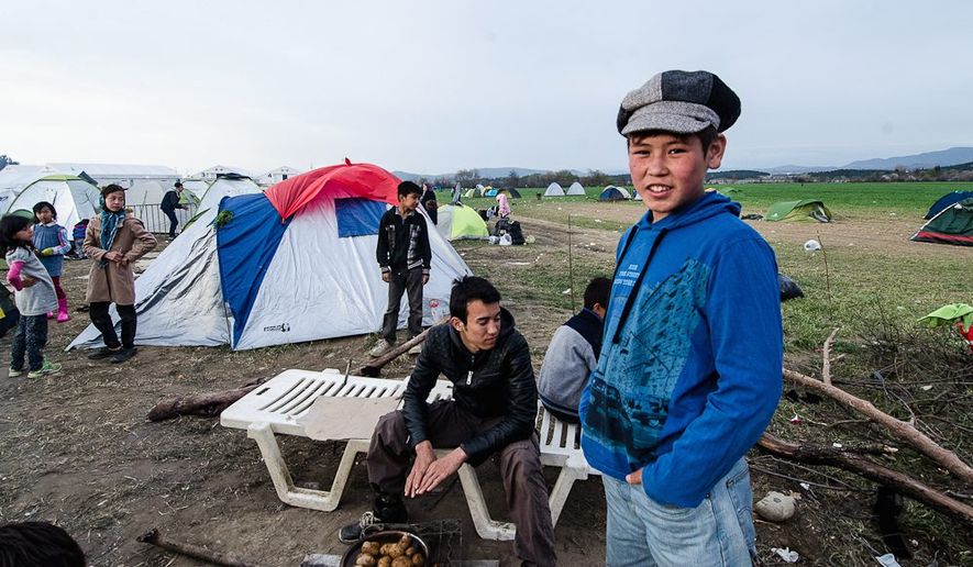Young Afghan refugees are left in limbo on the Greek-Macedonia border, where a makeshift refugee camp is struggling to handle the estimated 14,000 people stranded after Macedonia announced it would close its border with Greece. (Valerie Plesch/Special to the Washington Times)